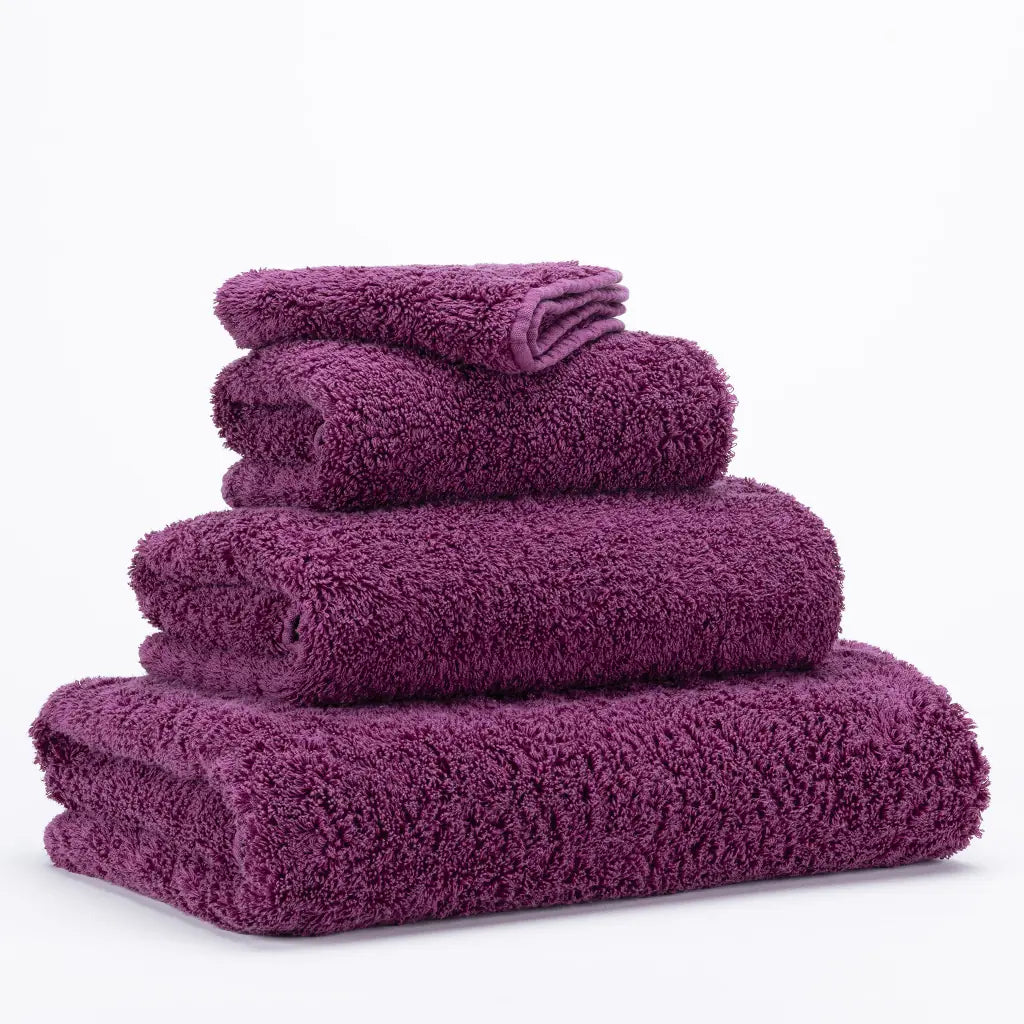 Stack of purple towels on a white background