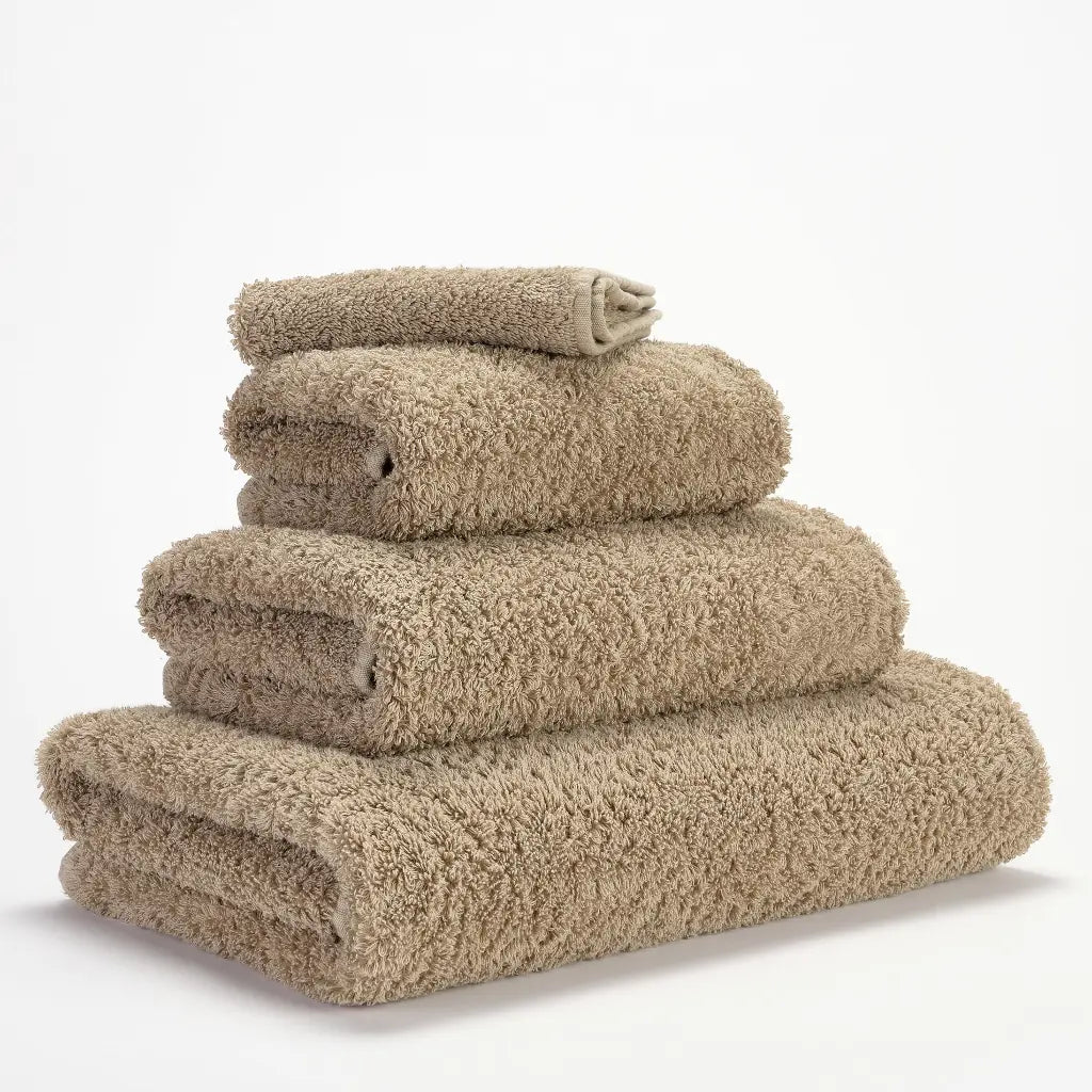 Stack of beige towels on a white background