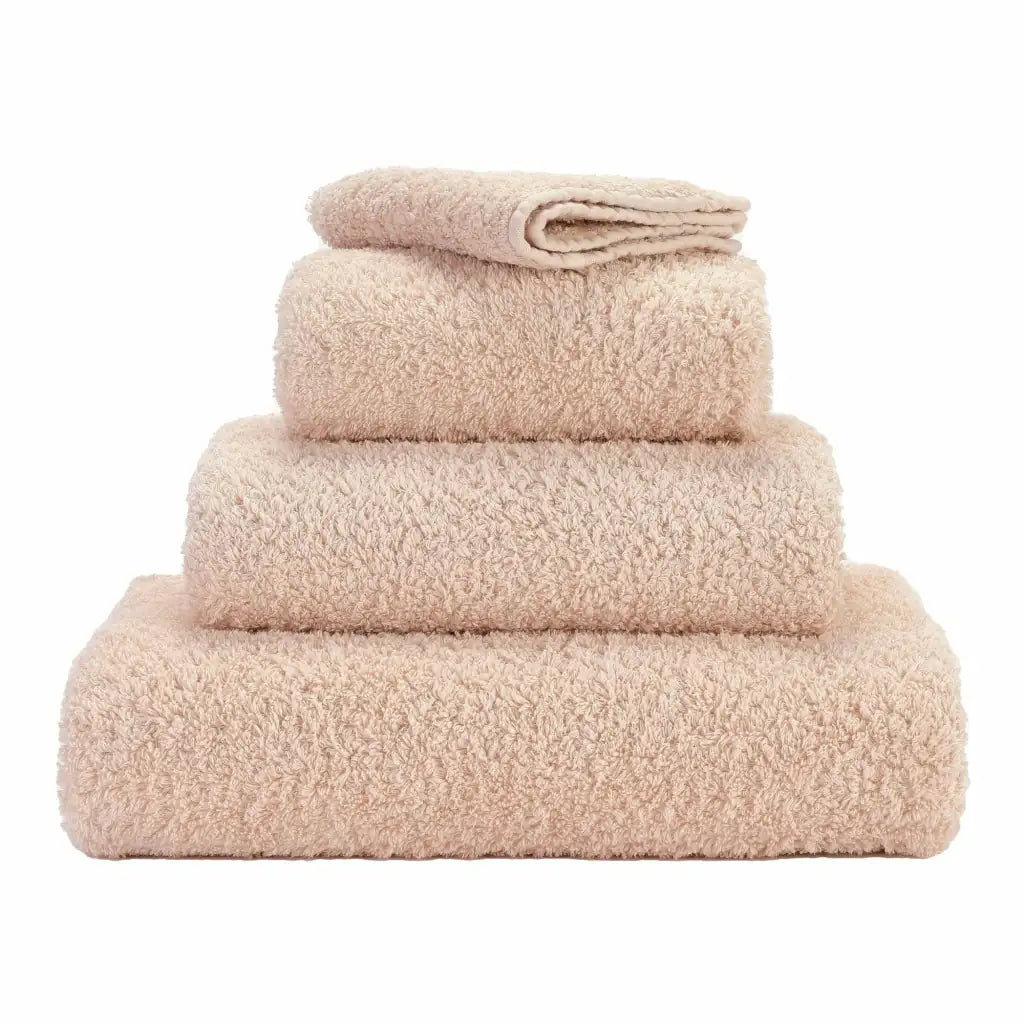 Stack of beige towels on a white background