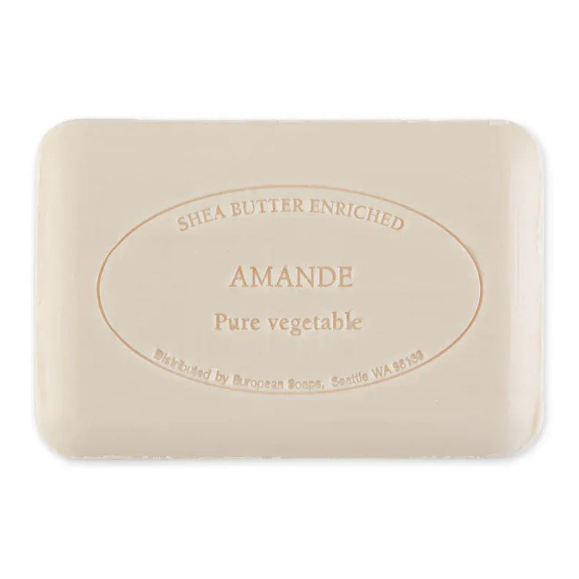 A rectangular bar of Shea Butter Enriched Amande Pure Vegetable soap, featuring a light beige color with embossed text in a circular oval design, shown on a plain white background.
