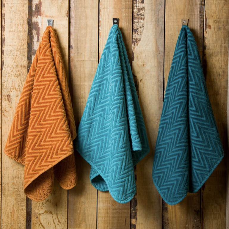 Abyss & Habidecor Montana Bath Towels hanging on wooden wall