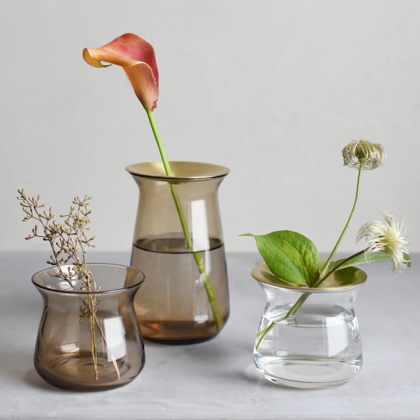 KINTO LUNA vases, 70mm and 130mm in Brown and clear holding flowers.