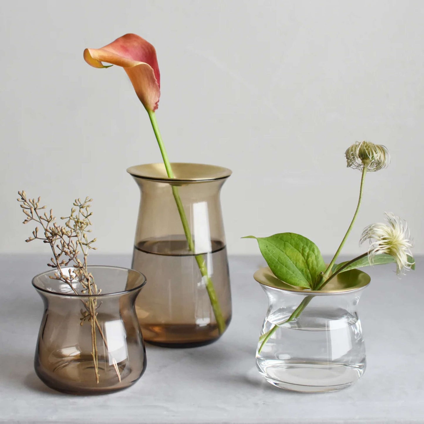 KINTO LUNA vases, 70mm and 130mm in Brown and clear holding flowers.
