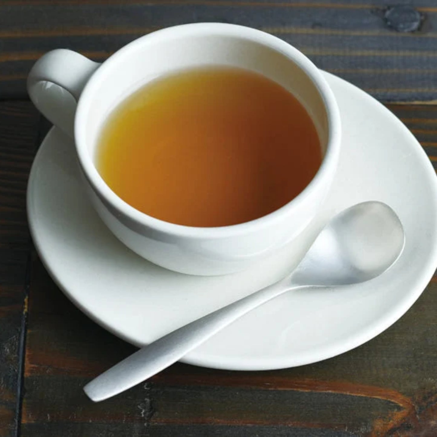 KINTO HIBI Teaspoon next to teacup with tea