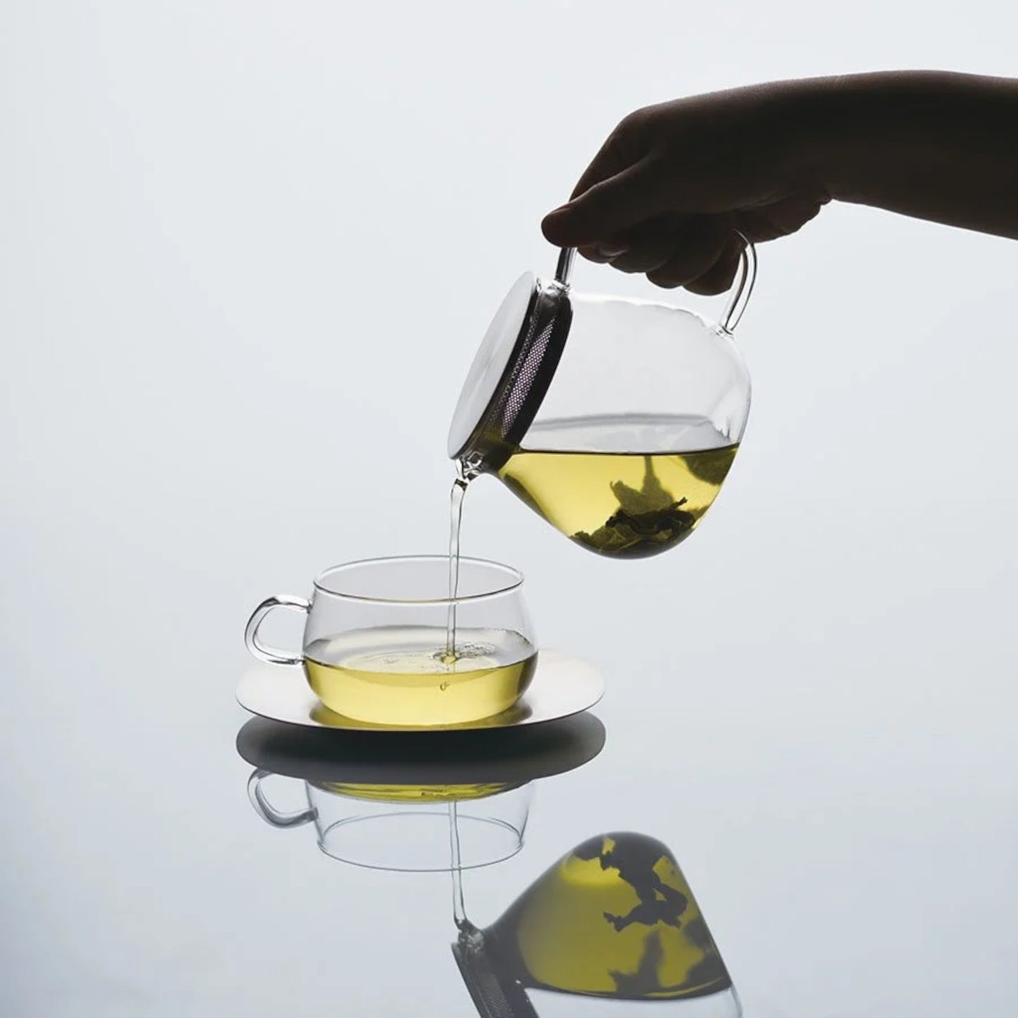 KINTO UNITEA One Touch teapot with pouring tea into teacup