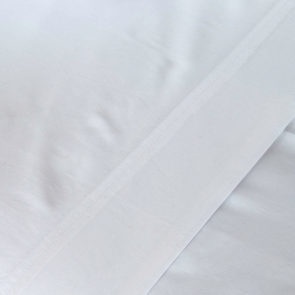 Close-up of white fabric with a subtle pattern