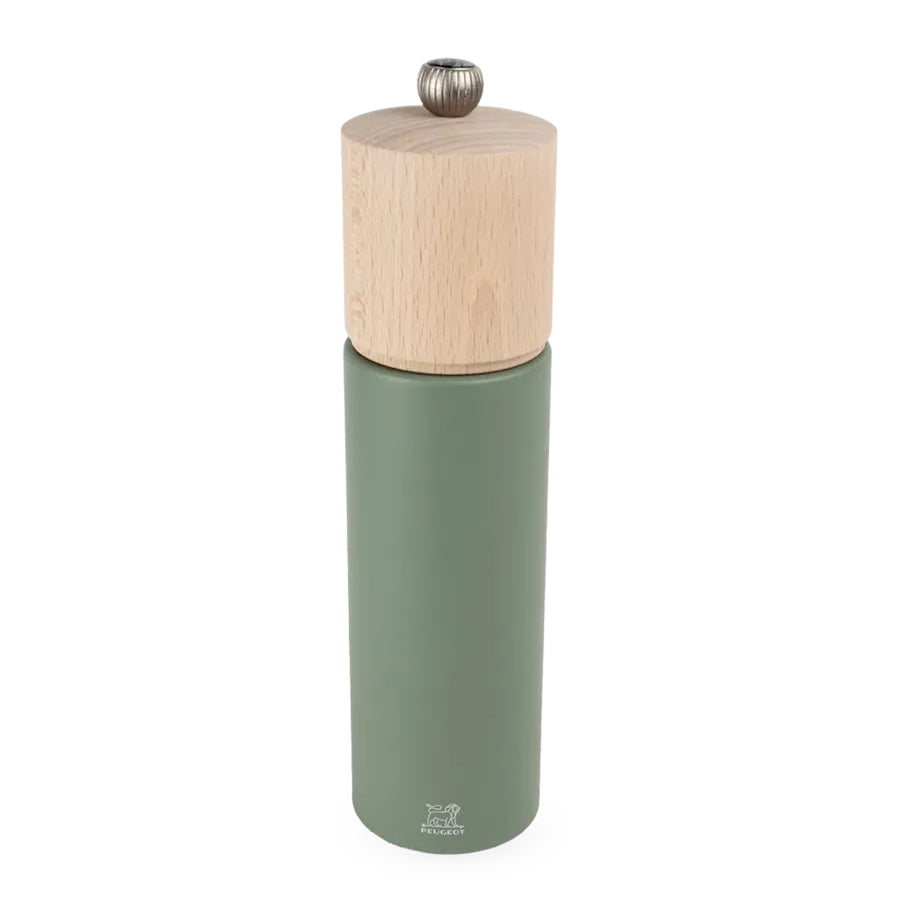 Green pepper grinder with wooden top on a white background