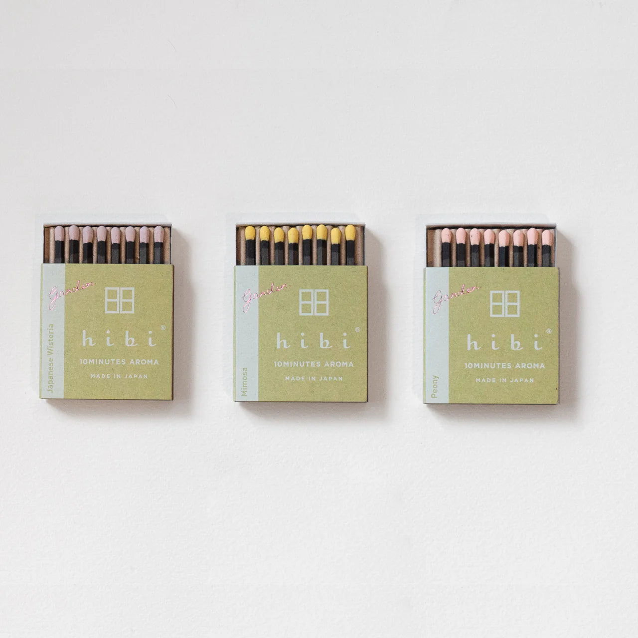 Three boxes of hibi matches on a white background
