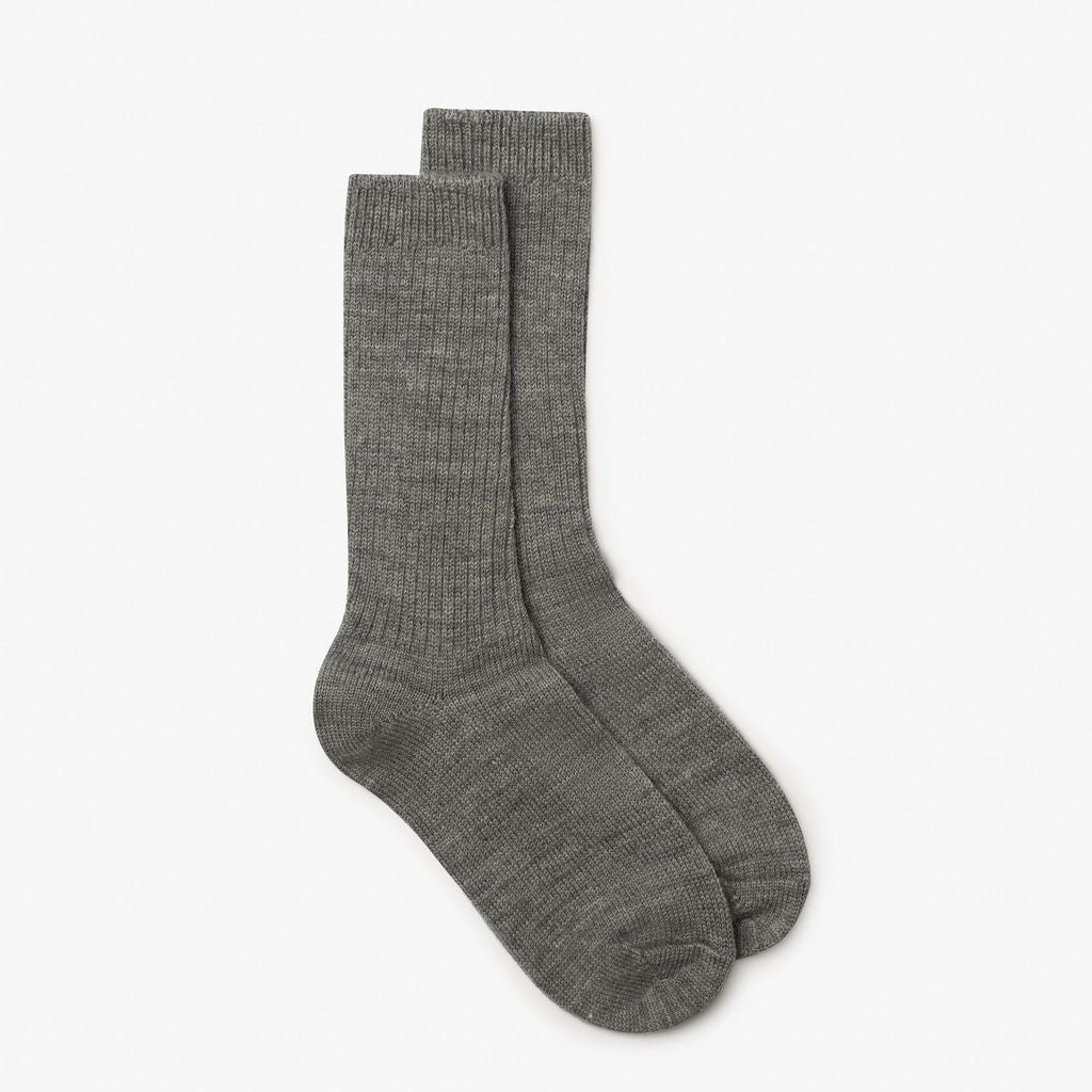 A pair of medium gray ribbed crew socks displayed against a clean, off-white background.