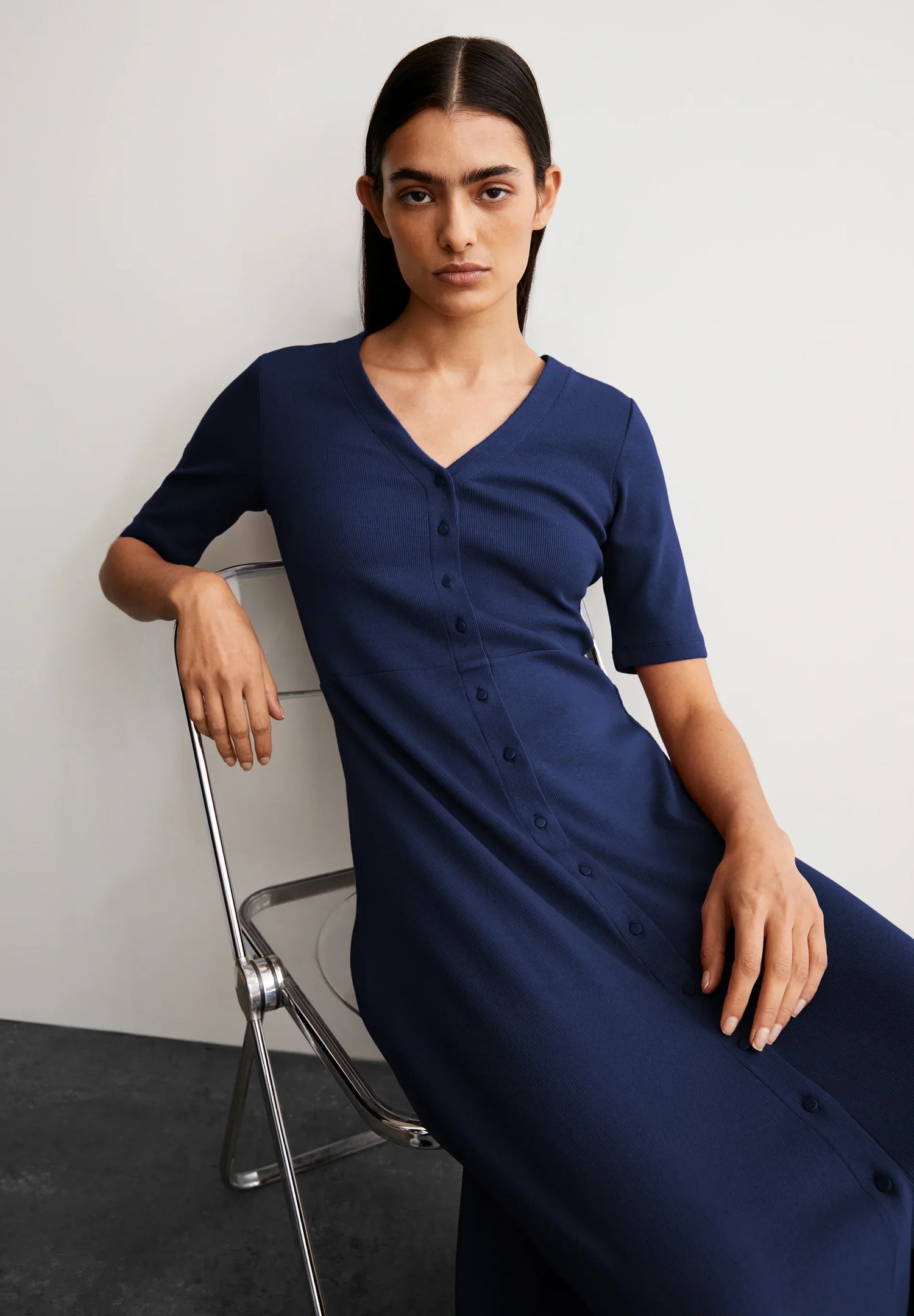 Woman wearing a navy blue sleeveless dress highlighting Made in Canada Dresses and Jumpsuits collection