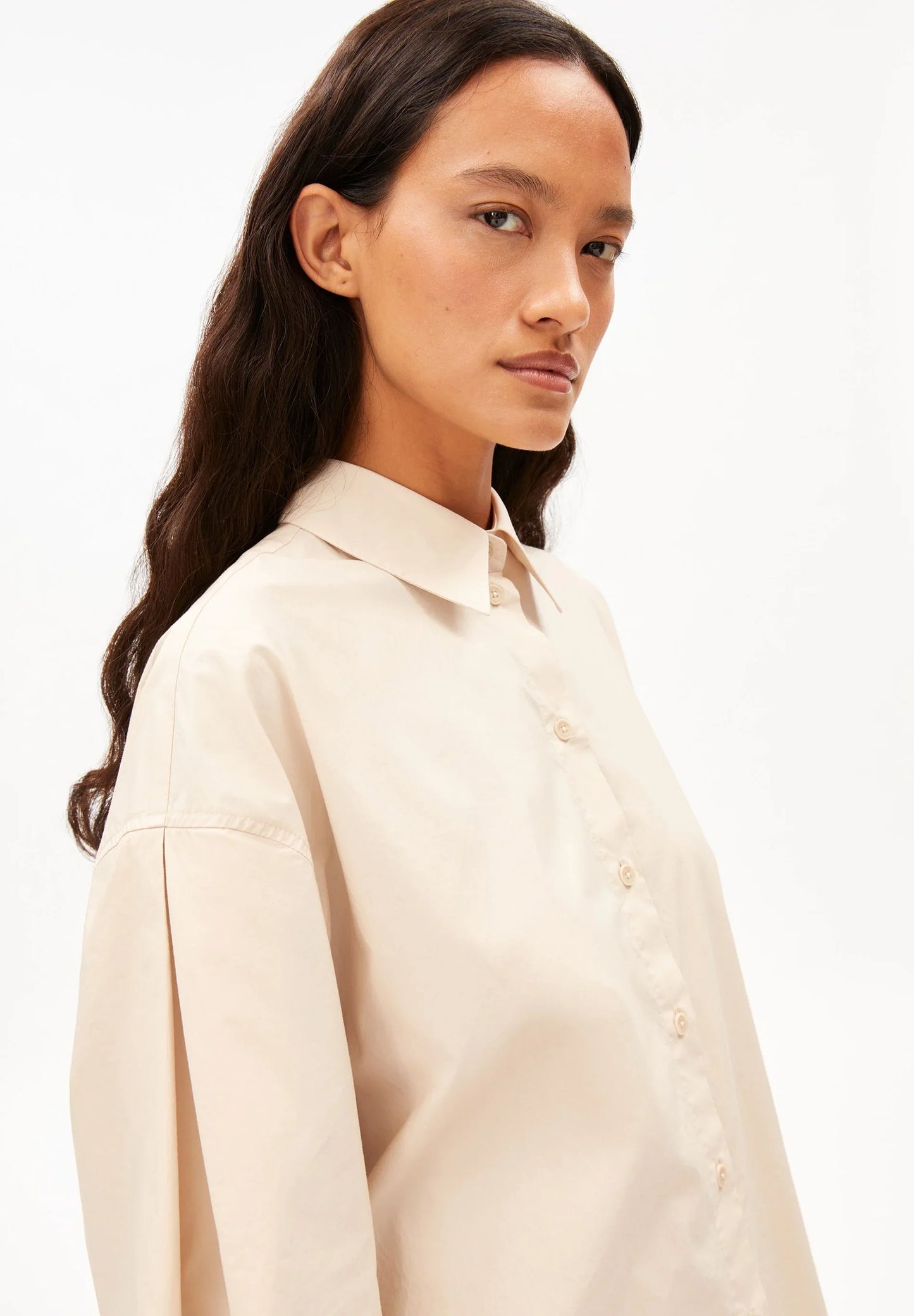 BARREL SLEEVE POPLIN BLOUSE in Pale Peach – ARMEDANGELS close-up view of collared shirt on model