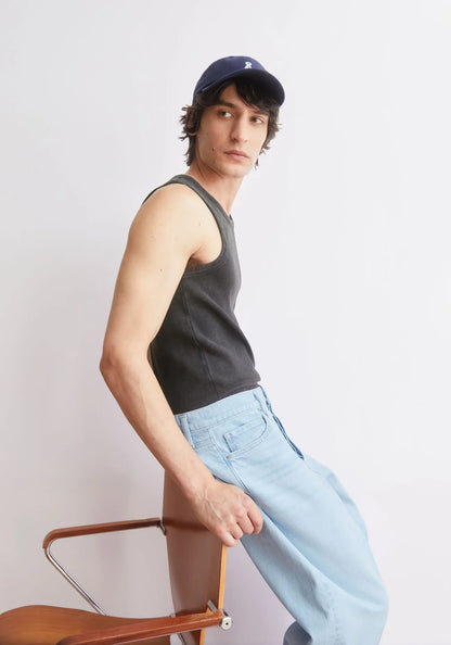 GMT DYE TANK TOP in Black-wash - ARMEDANGELS Canada garment dye black men's tank top side view styled on a model with baseball cap and jeans