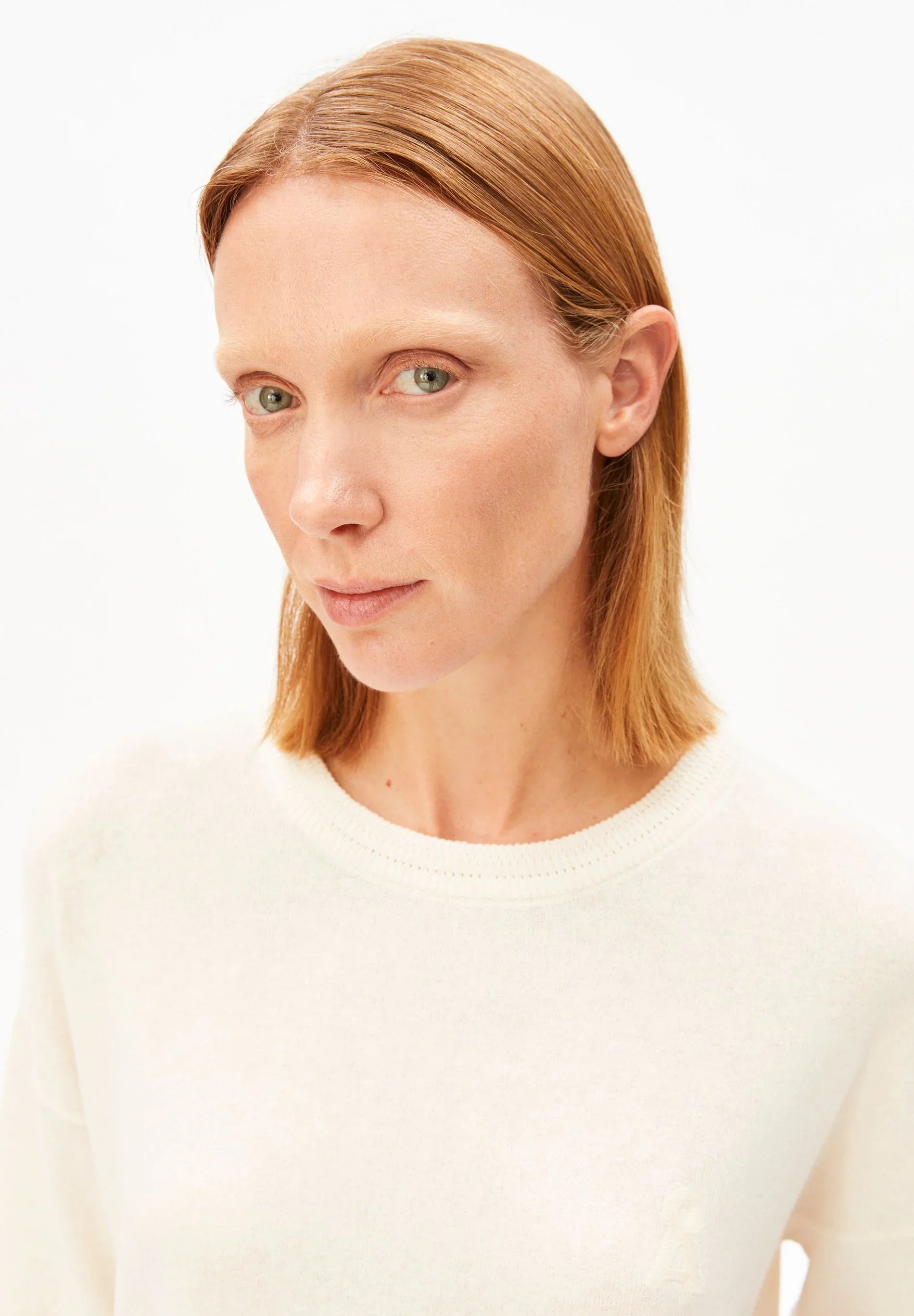 Close up of round neck Linen Blend Knit Sweater in Undyed – ARMEDANGELS Canada on model