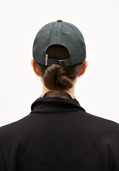 Person wearing a gray cap from behind on a white background