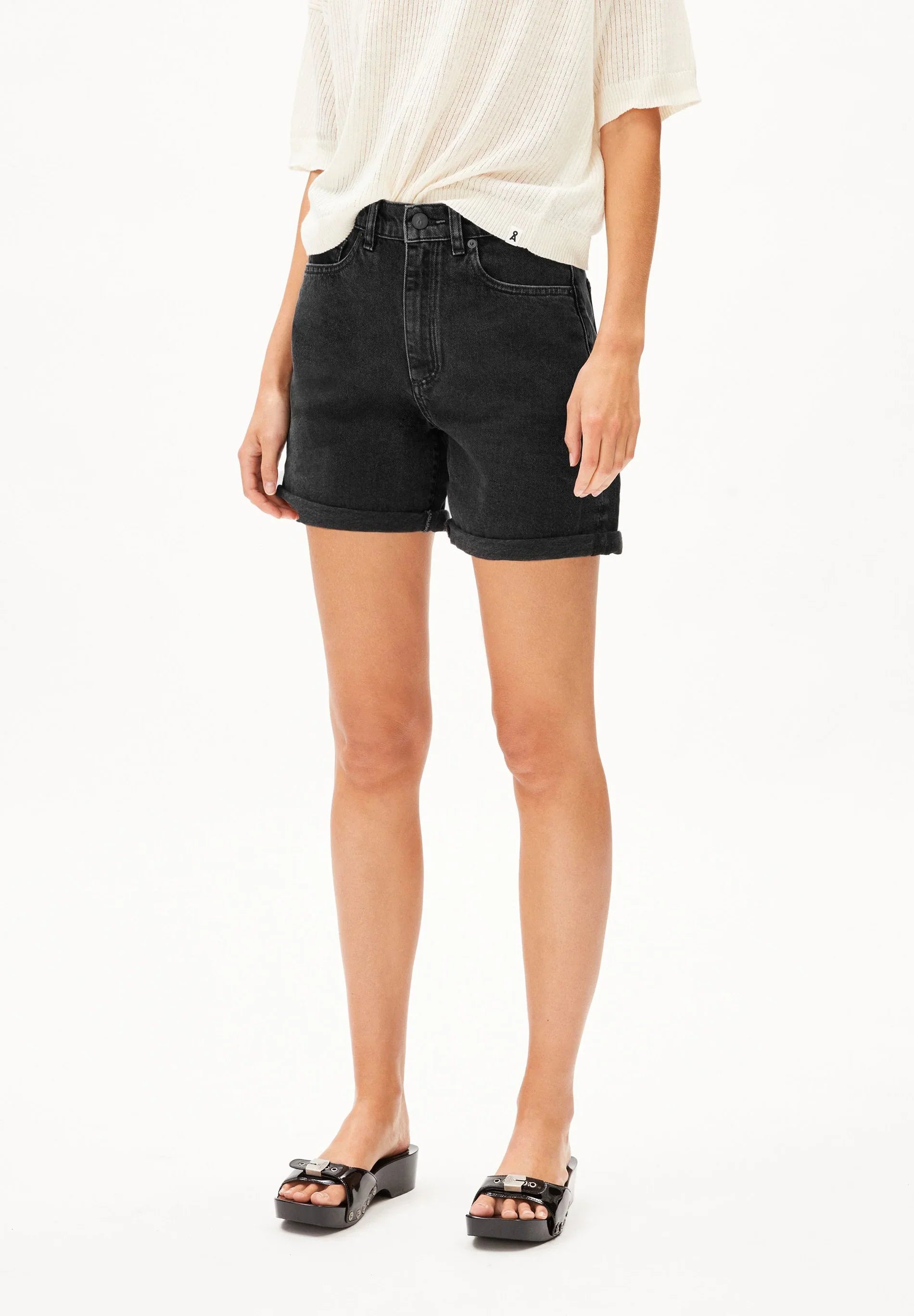 Person wearing black denim shorts on a white background for Kelowna and Canada