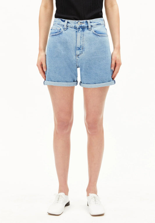 Person wearing light blue denim shorts on a white background for Kelowna and Canada