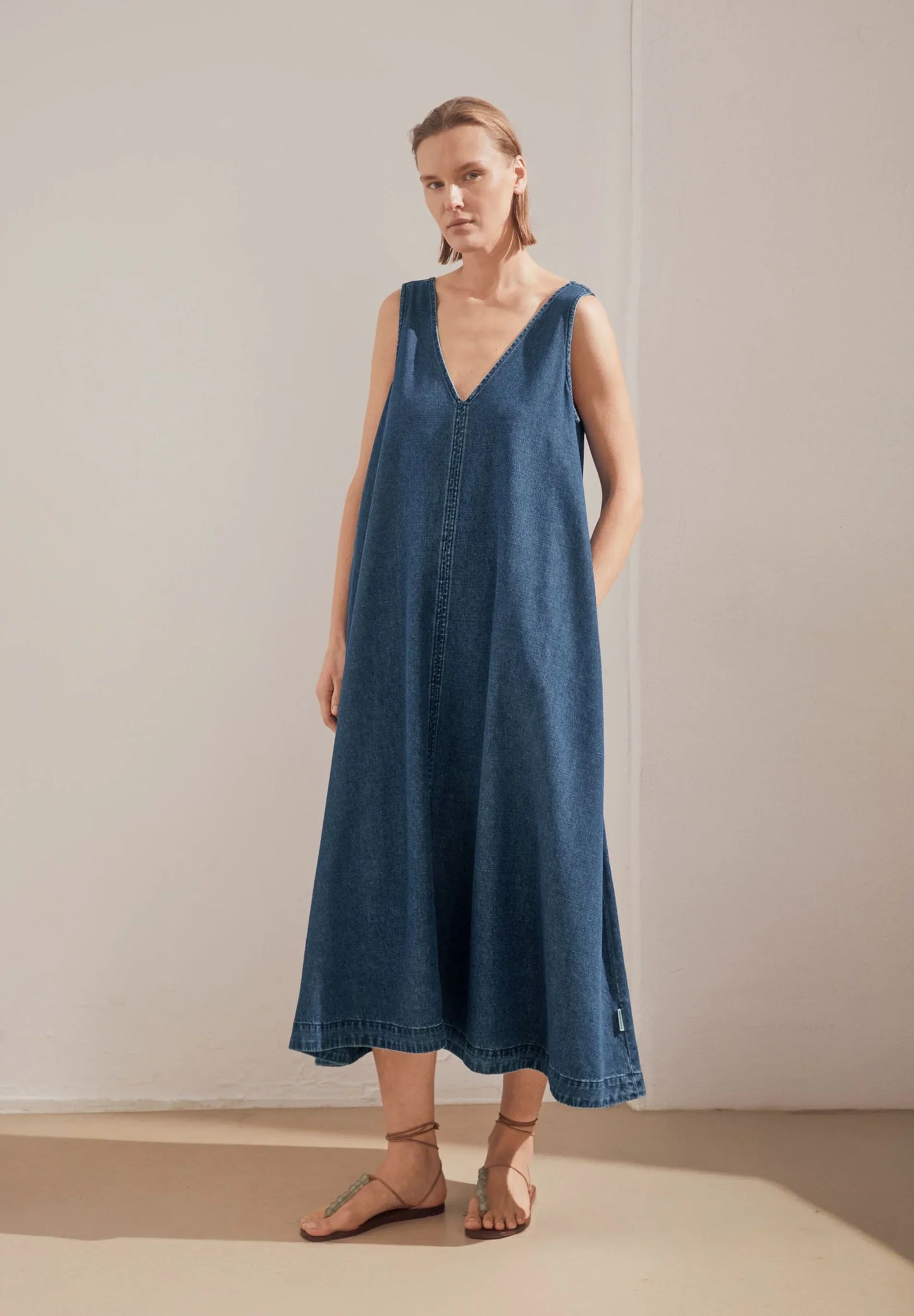 women's ARMEDANGELS Canada Denim V-Neck Midi Dress in Eau, full model front view lifestyle shot  in Kelowna
