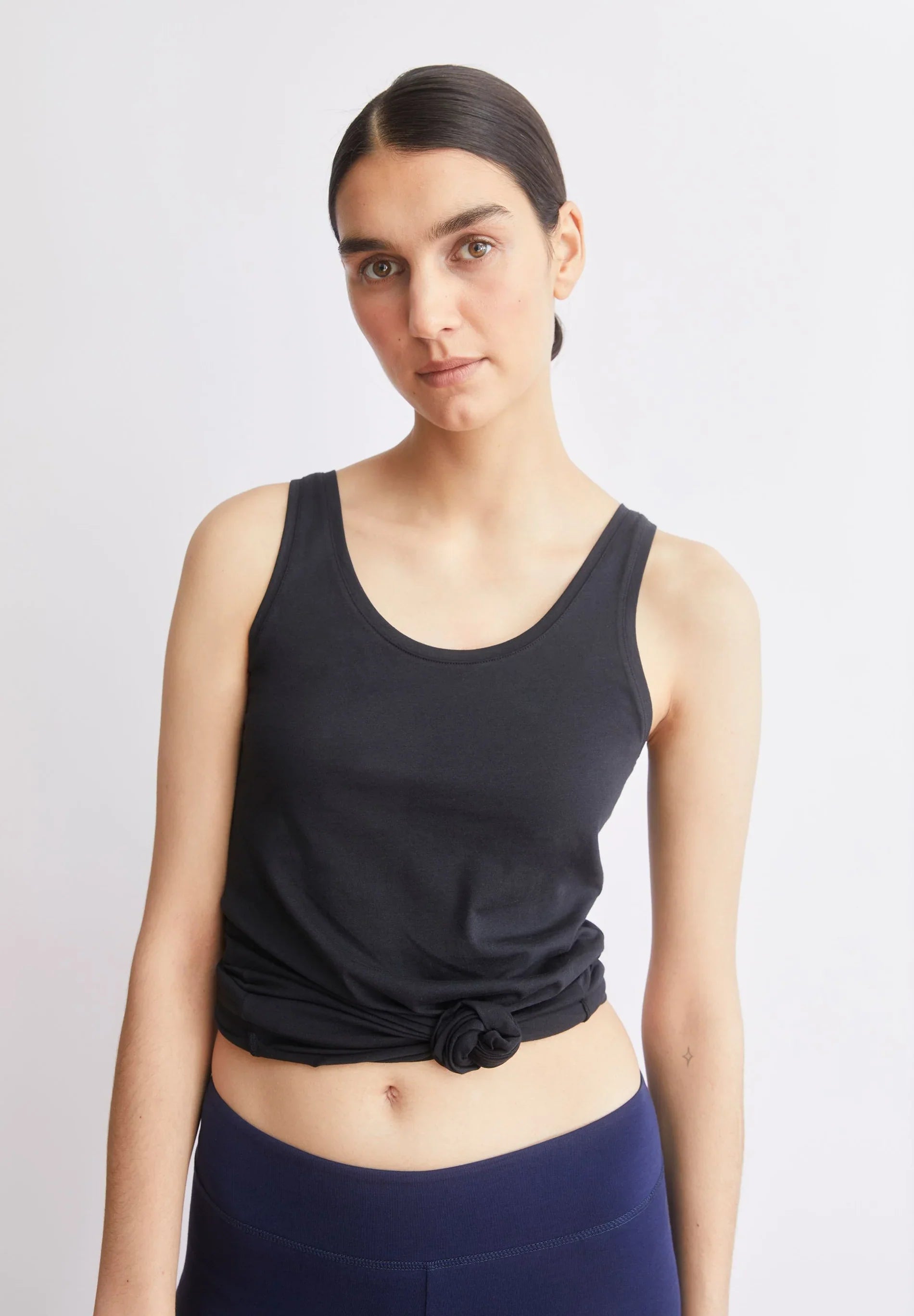 women's ARMEDANGELS Canada Single Jersey Top in Black, view on model tied with a knot  in Kelowna