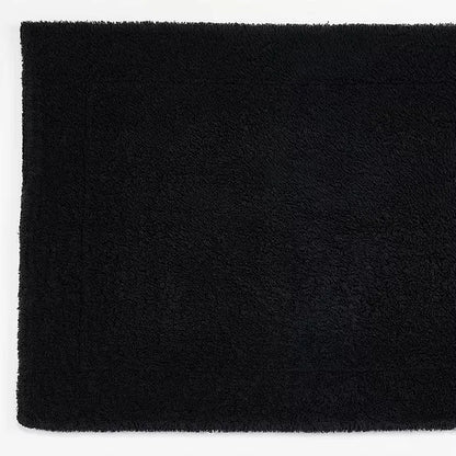 Solid black tub mat on a white background