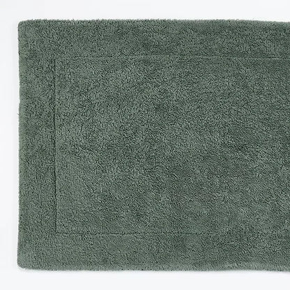 Green bath mat on a white background