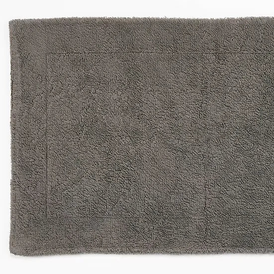 Gray bath mat with a textured surface on a white background