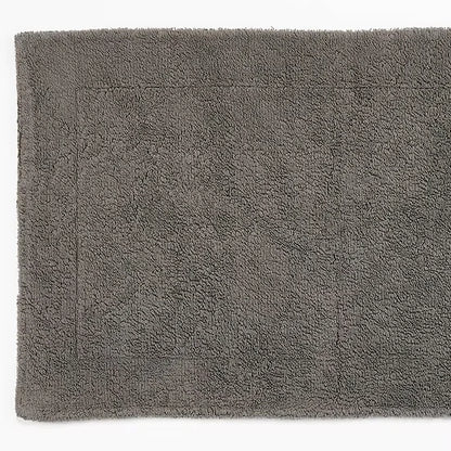 Gray bath mat with a textured surface on a white background
