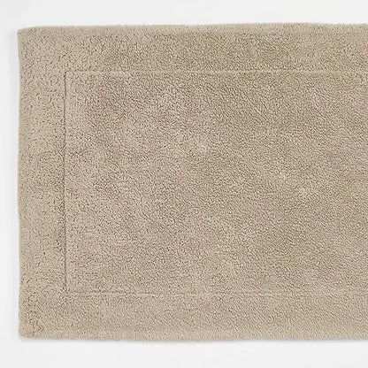 Beige bath mat on a white background