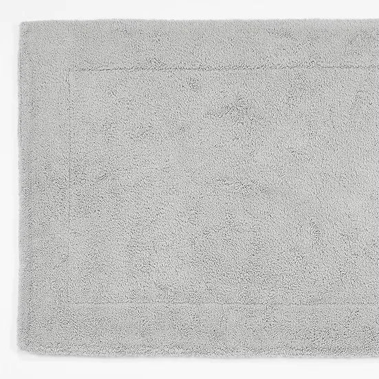 Gray bath mat with a textured surface on a white background