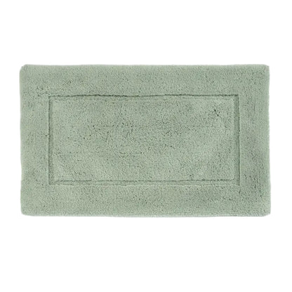 Green bath mat on a white background