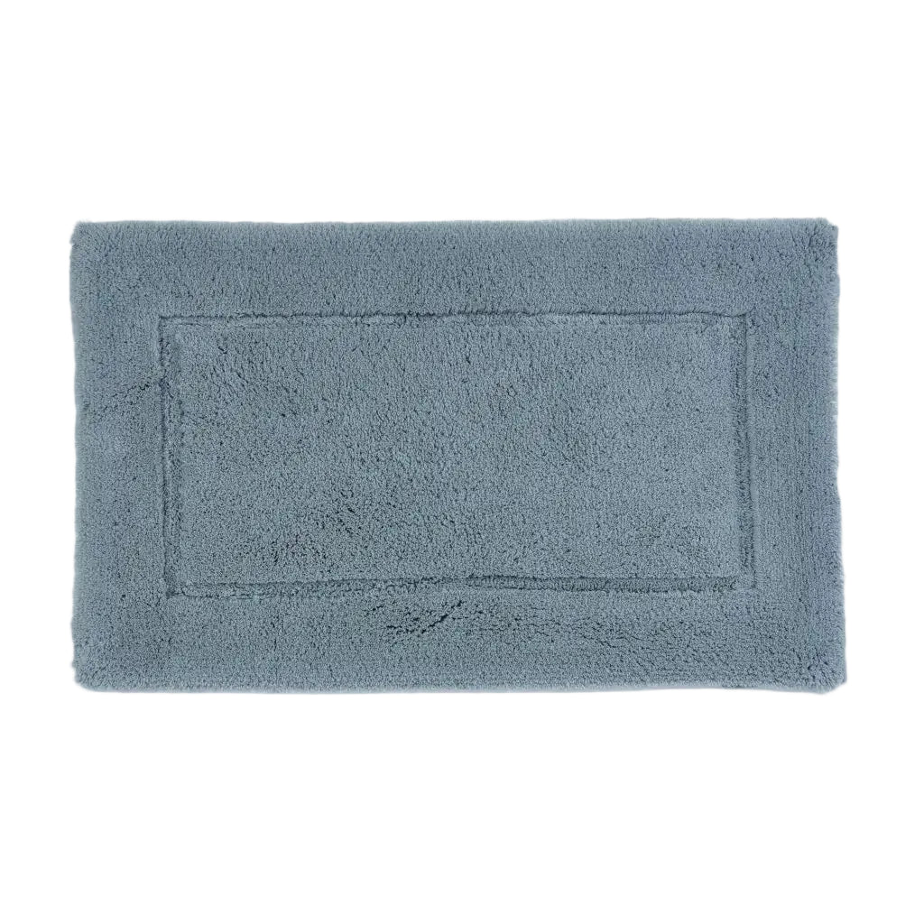 Rectangular blue bath mat on a white background