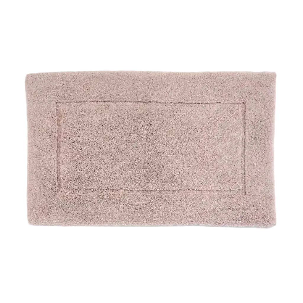 Light pink bath mat on a white background