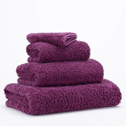 Stack of purple towels on a white background