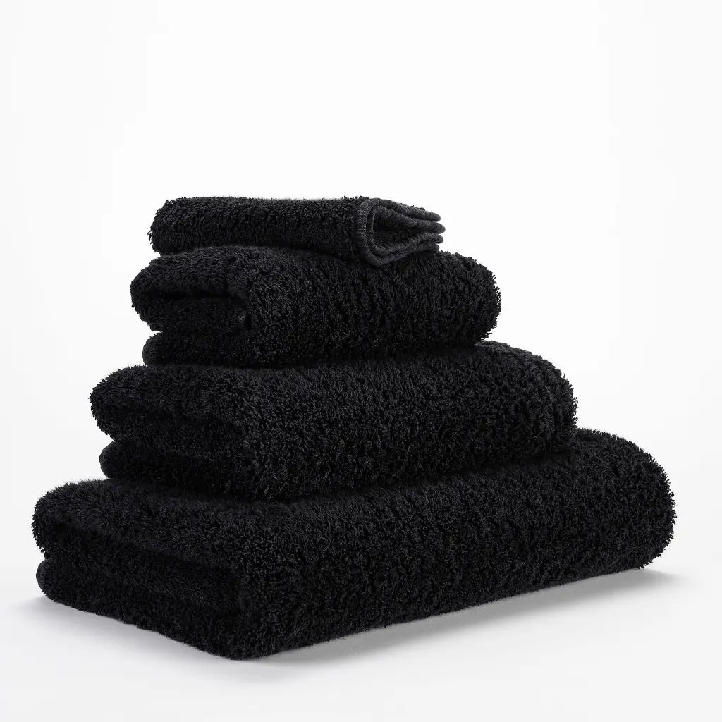 Stack of black towels on a white background