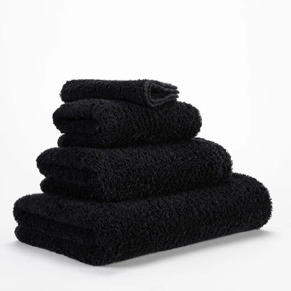 Stack of black towels on a white background