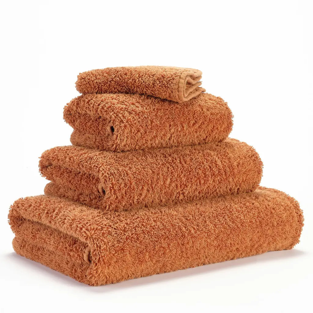 Stack of caramel towels on a white background