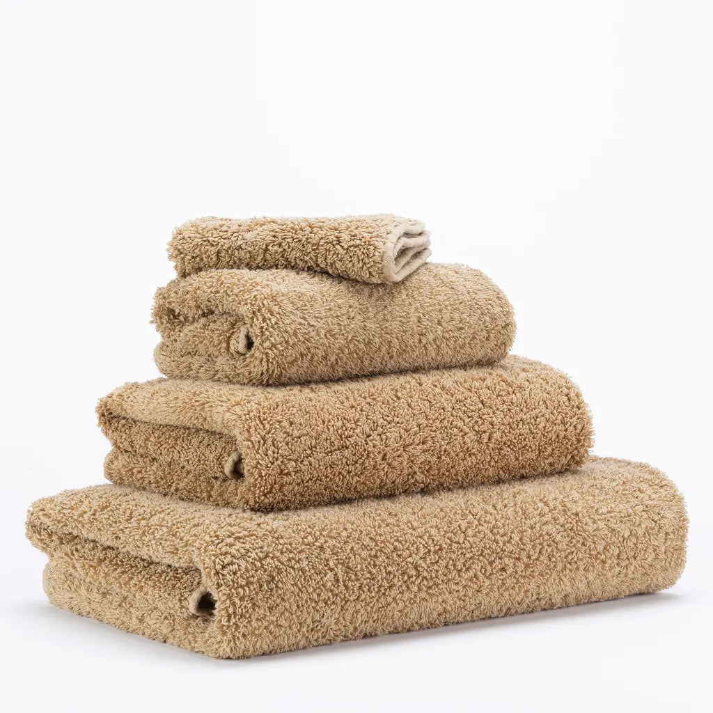 Stack of beige towels on a white background