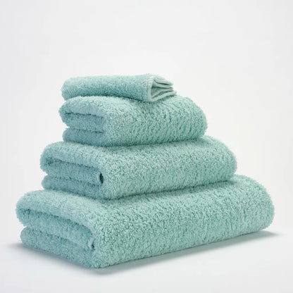 Stack of light blue towels on a white background