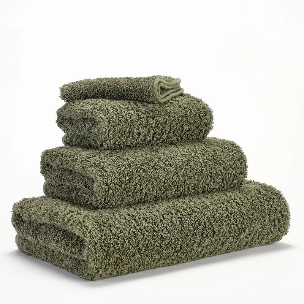 Stack of green towels on a white background