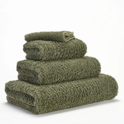 Stack of green towels on a white background
