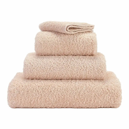 Stack of beige towels on a white background