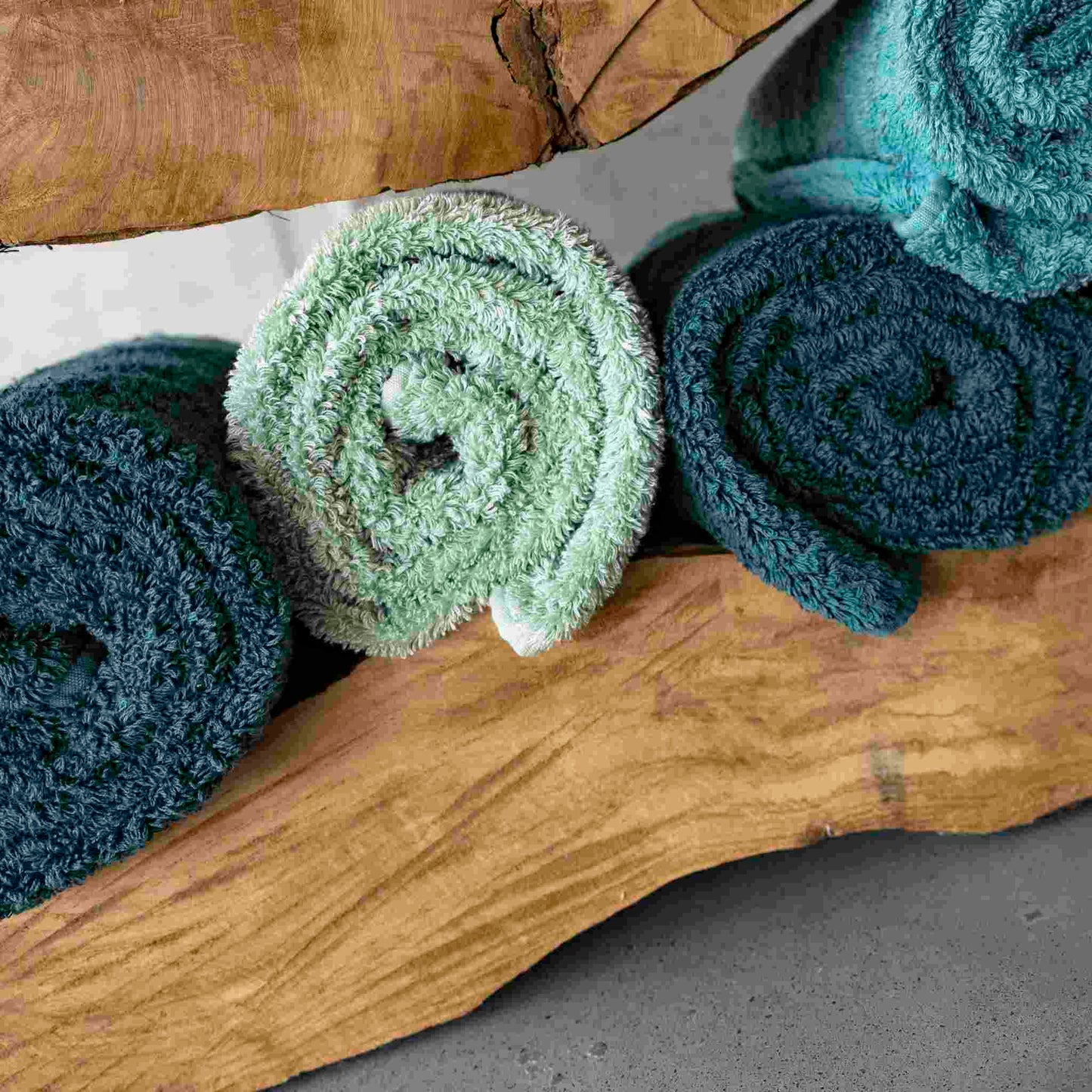 Abyss & Habidecor Super Pile Towels In blue/green, rolled up