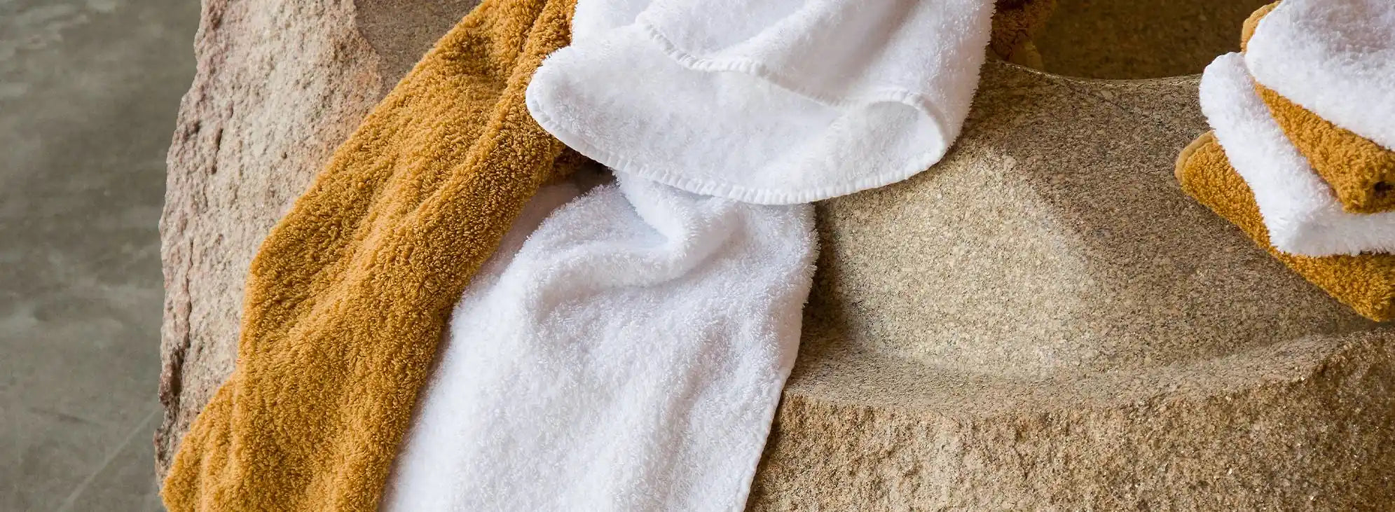 Abyss and Habidecor Towels, Displayed on a rock