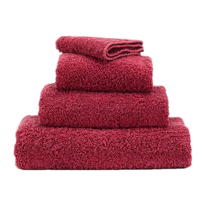 Stack of red towels on a white background