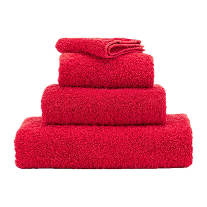 Stack of red towels on a white background