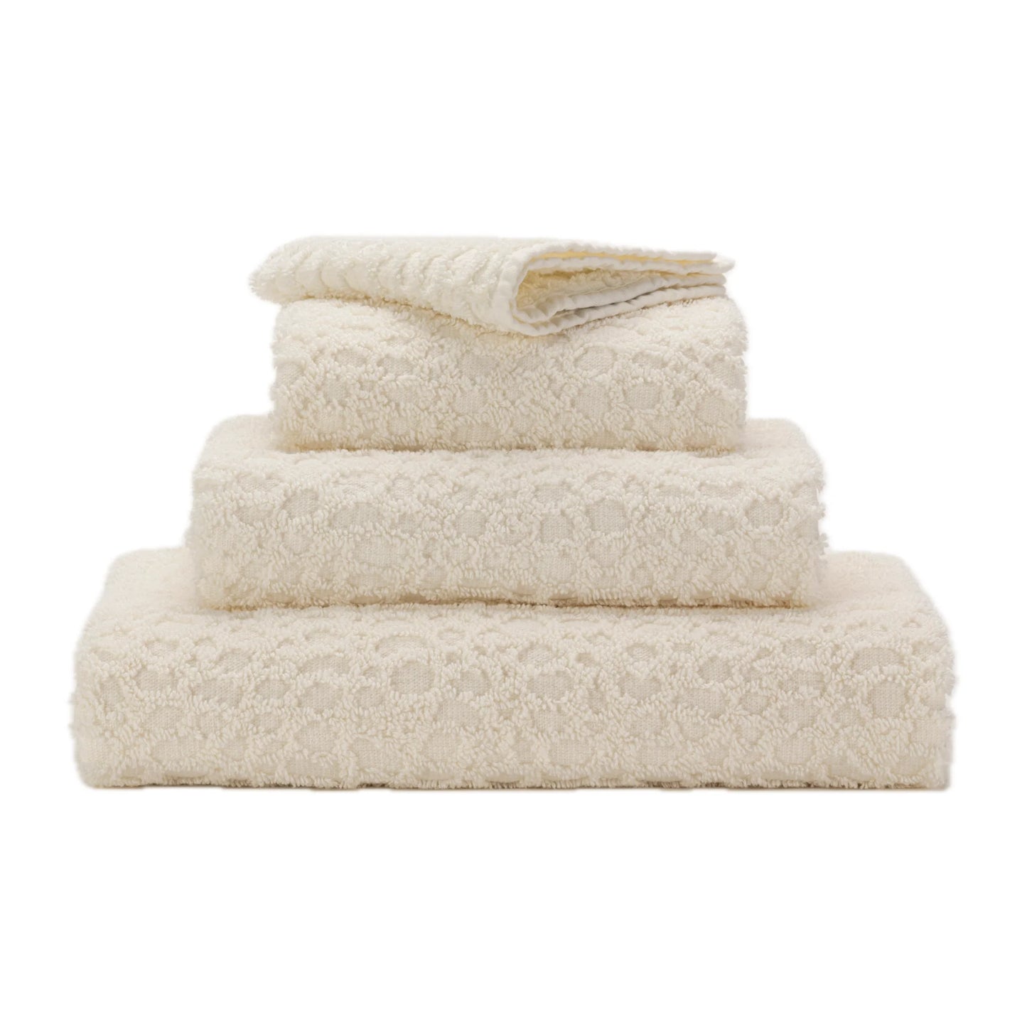 Stack of beige towels on a white background