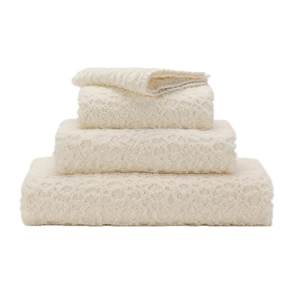 Stack of beige towels on a white background