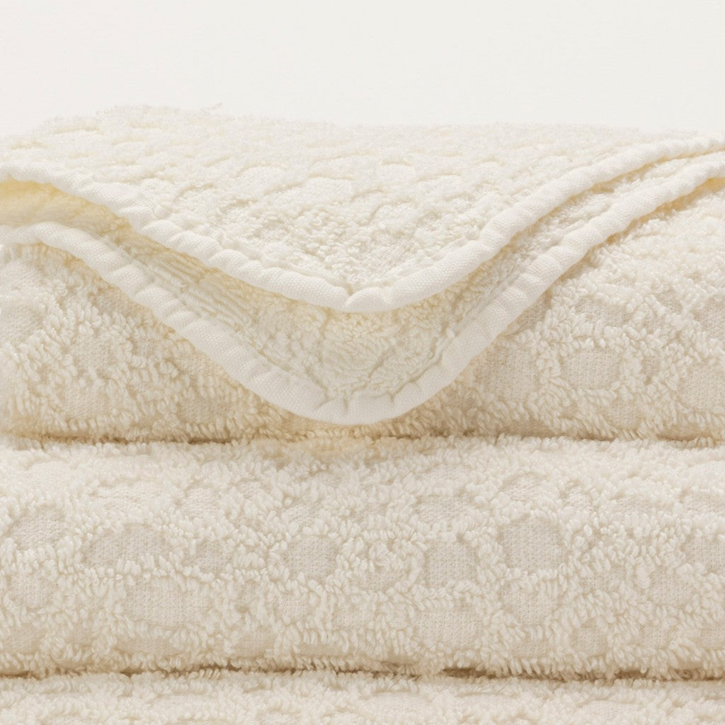Close-up of a cream-colored towel with textured surface