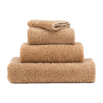 Stack of beige towels on a white background