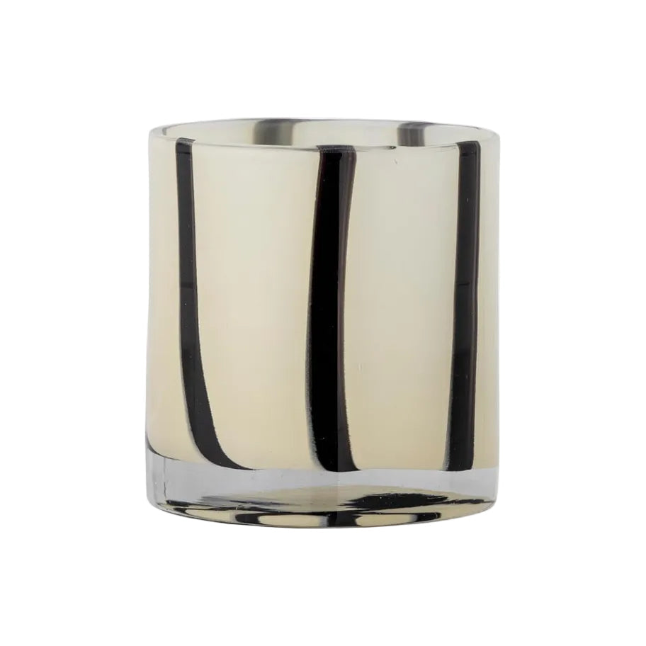 A mouth-blown glass votive vase with vertical stripes, primarily clear glass with black stripes, intended for home decor.