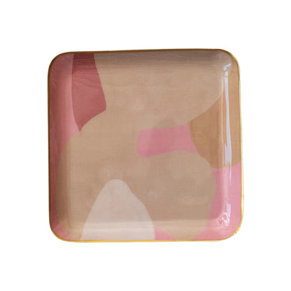A square enamel metal tray with an abstract pattern in beige and pink colors.